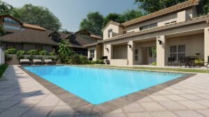 A rectangular outdoor swimming pool with clear blue water, surrounded by a paved patio, lounge chairs, tables, and a two-story house in the background.