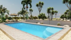 Rectangular swimming pool surrounded by stone tiles, palm trees, lounge chairs, and an umbrella, with a fence and sandy landscape in the background.