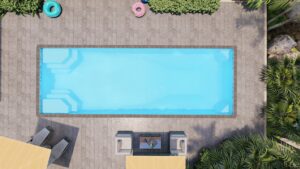 A rectangular swimming pool viewed from above, with pool floats, patio furniture, and greenery surrounding the pool area.