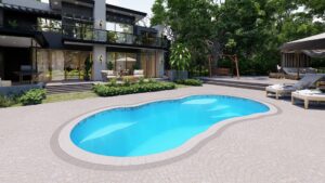 Lelani model fiberglass pool with vibrant blue water, surrounded by landscaped patio and outdoor furniture, showcasing Eco Landscaping Design's pool installation expertise.