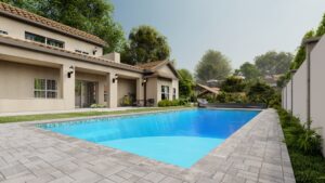 Rectangular swimming pool in a backyard with tiled patio, surrounded by greenery and a beige house with large windows and outdoor furniture.